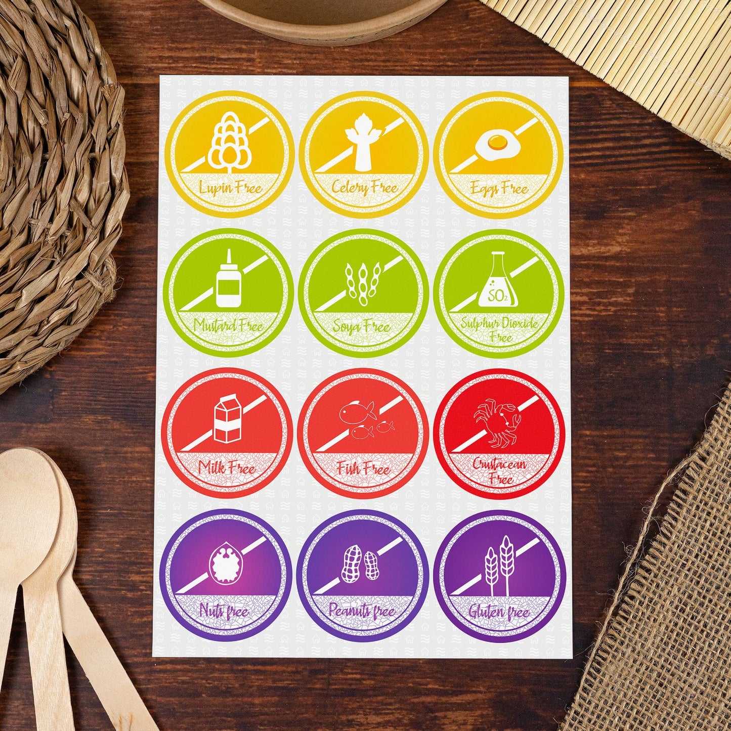 Sheet of circular food allergen labels on a wooden background, featuring icons and text for 'Lupin Free,' 'Celery Free,' 'Eggs Free,' 'Mustard Free,' 'Soya Free,' 'Sulphur Dioxide Free,' 'Milk Free,' 'Fish Free,' 'Crustacean Free,' 'Nuts Free,' 'Peanuts Free,' and 'Gluten Free.' Ideal for restaurants, food businesses, or home kitchens to clearly mark allergen-free items