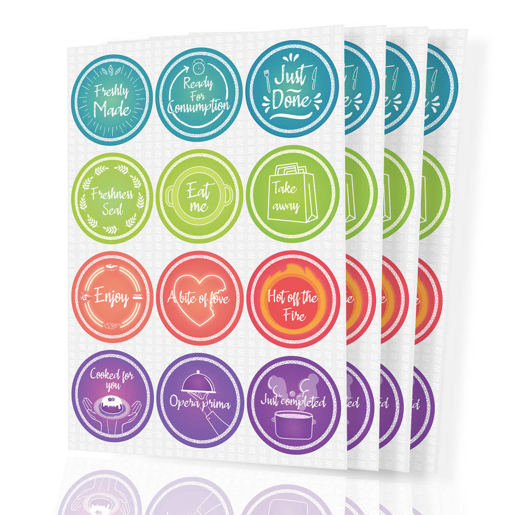 Stack of sheets featuring colorful circular food preparation and serving labels. Each sticker has unique text and icons like 'Freshly Made,' 'Ready for Consumption,' 'Just Done,' 'Freshness Seal,' 'Eat me,' 'Take away,' 'Enjoy,' 'A bite of love,' 'Hot off the Fire,' 'Cooked for you,' 'Opera prima,' and 'Just completed,' ideal for food businesses or home cooking